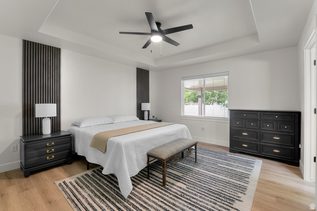 886 River Ridge Lane Spanish Fork, UT 84660 - Photo 8 of 31 Master bedroom with Recessed tray ceiling with a ceiling fan, wood-finish flooring, and a large window with blinds