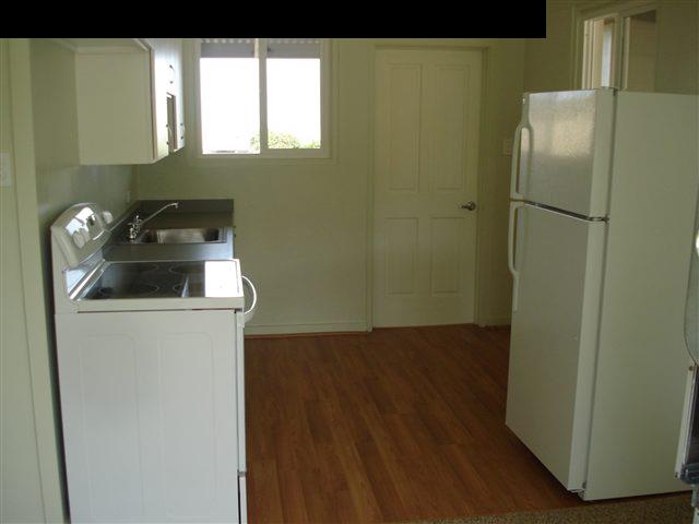 35 Maha Road, Unit 3 Makawao, HI 96768 - Photo 3 of 4 a kitchen with a refrigerator and window