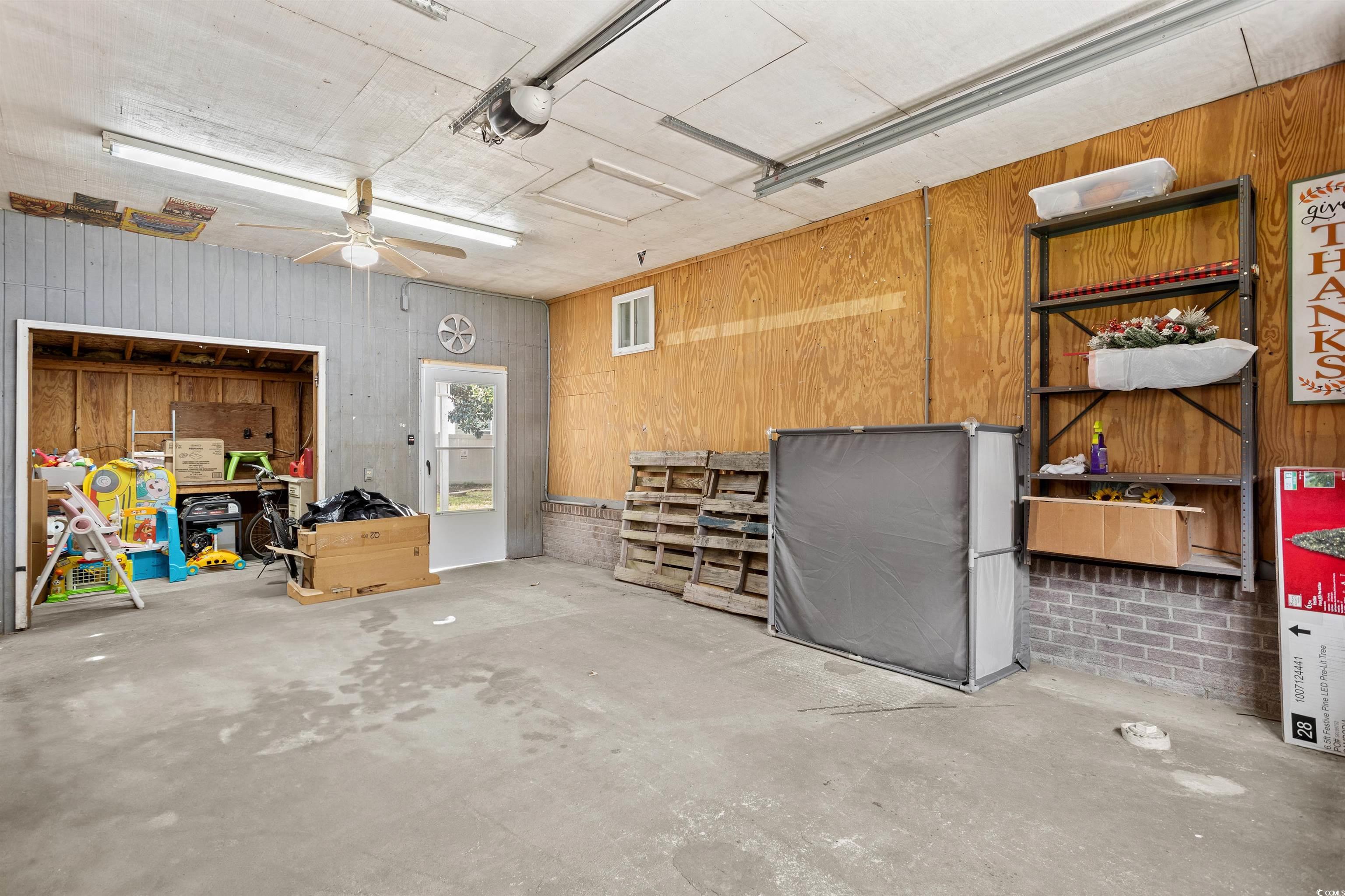 949 Derrick Lane Murrells Inlet, SC 29576 - Photo 33 of 40 Garage featuring wooden walls and ceiling fan