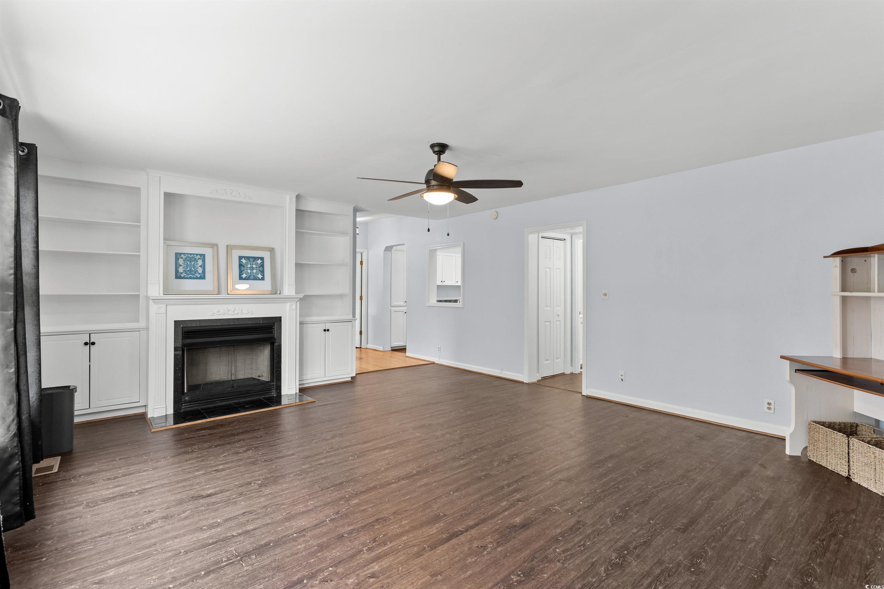 949 Derrick Lane Murrells Inlet, SC 29576 - Photo 7 of 40 Unfurnished living room featuring built in shelves