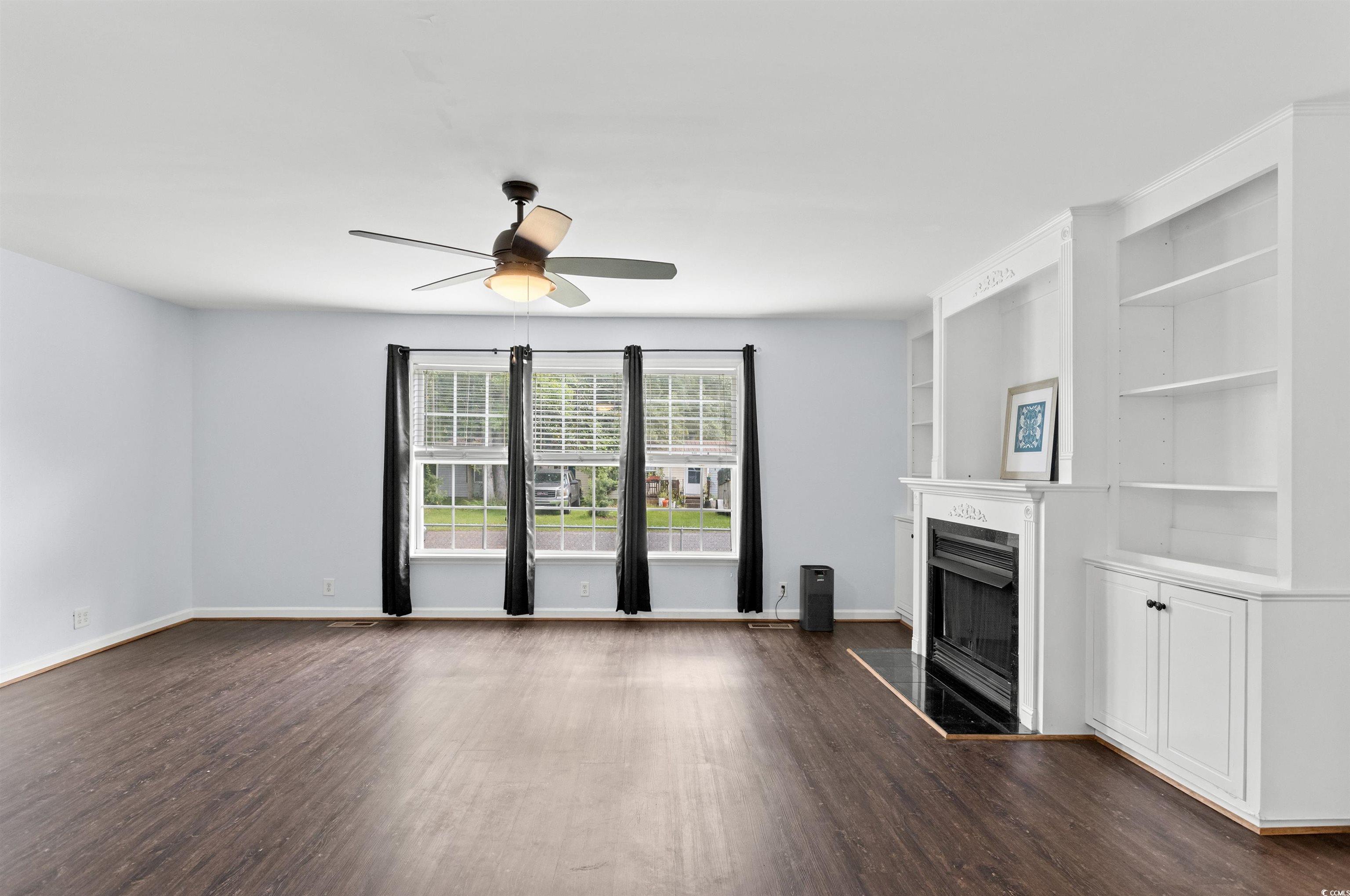 949 Derrick Lane Murrells Inlet, SC 29576 - Photo 8 of 40 Unfurnished living room featuring ceiling fan and