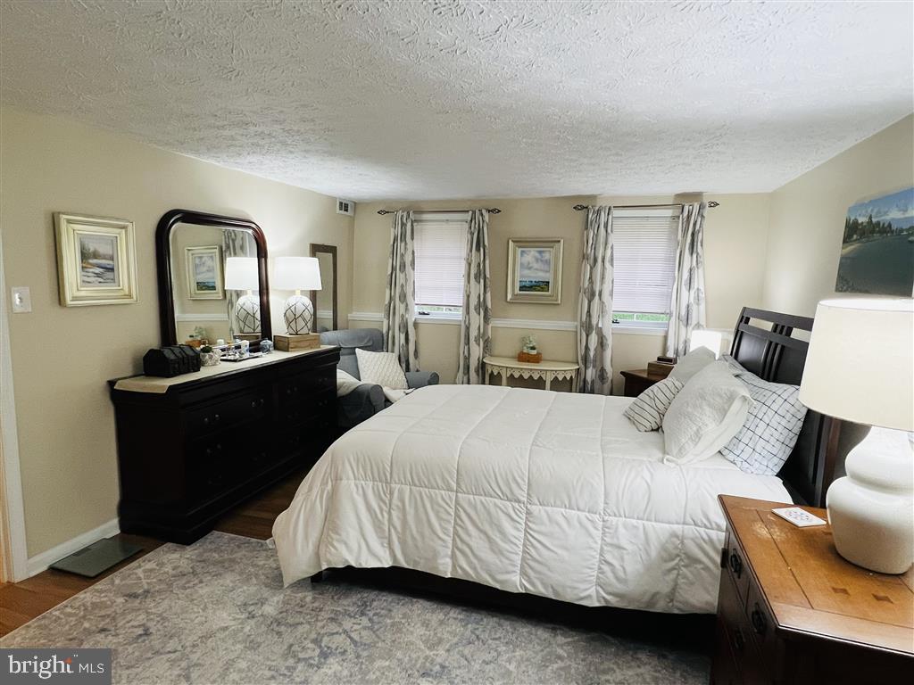 624 Southern Hills Drive, Unit B2A Arnold, MD 21012 - Photo 11 of 13 a bedroom with a bed and wooden floor