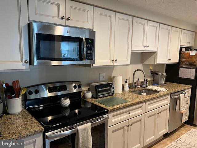 624 Southern Hills Drive, Unit B2A Arnold, MD 21012 - Photo 2 of 13 a kitchen with stainless steel appliances granite countertop a stove a microwave and cabinets