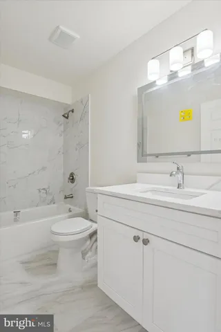 a bathroom with a sink a toilet and bathtub