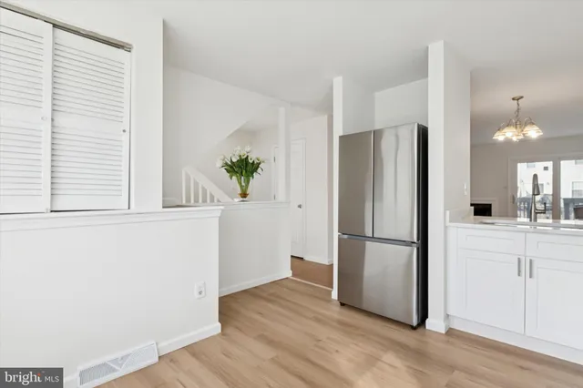 a kitchen with a refrigerator a microwave and sink
