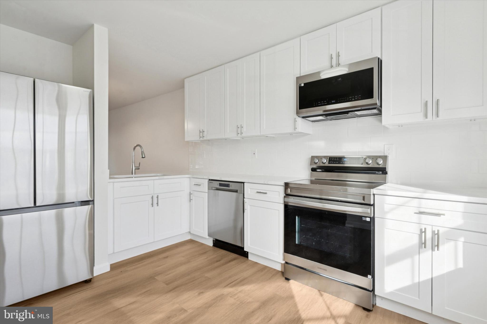 110 Hawk Drive Newark, DE 19702 - Photo 19 of 25 a kitchen with cabinets stainless steel appliances and wooden floor