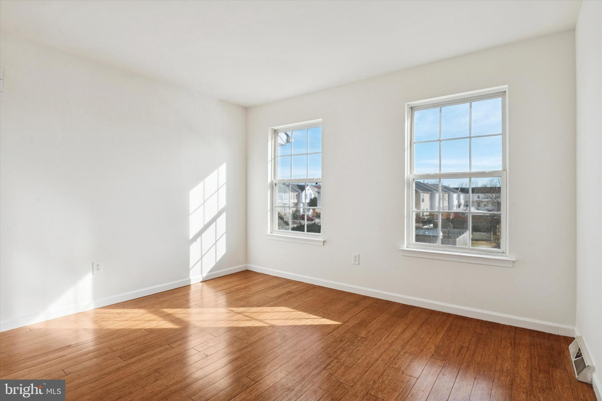 110 Hawk Drive Newark, DE 19702 - Photo 7 of 25 an empty room with wooden floor and windows