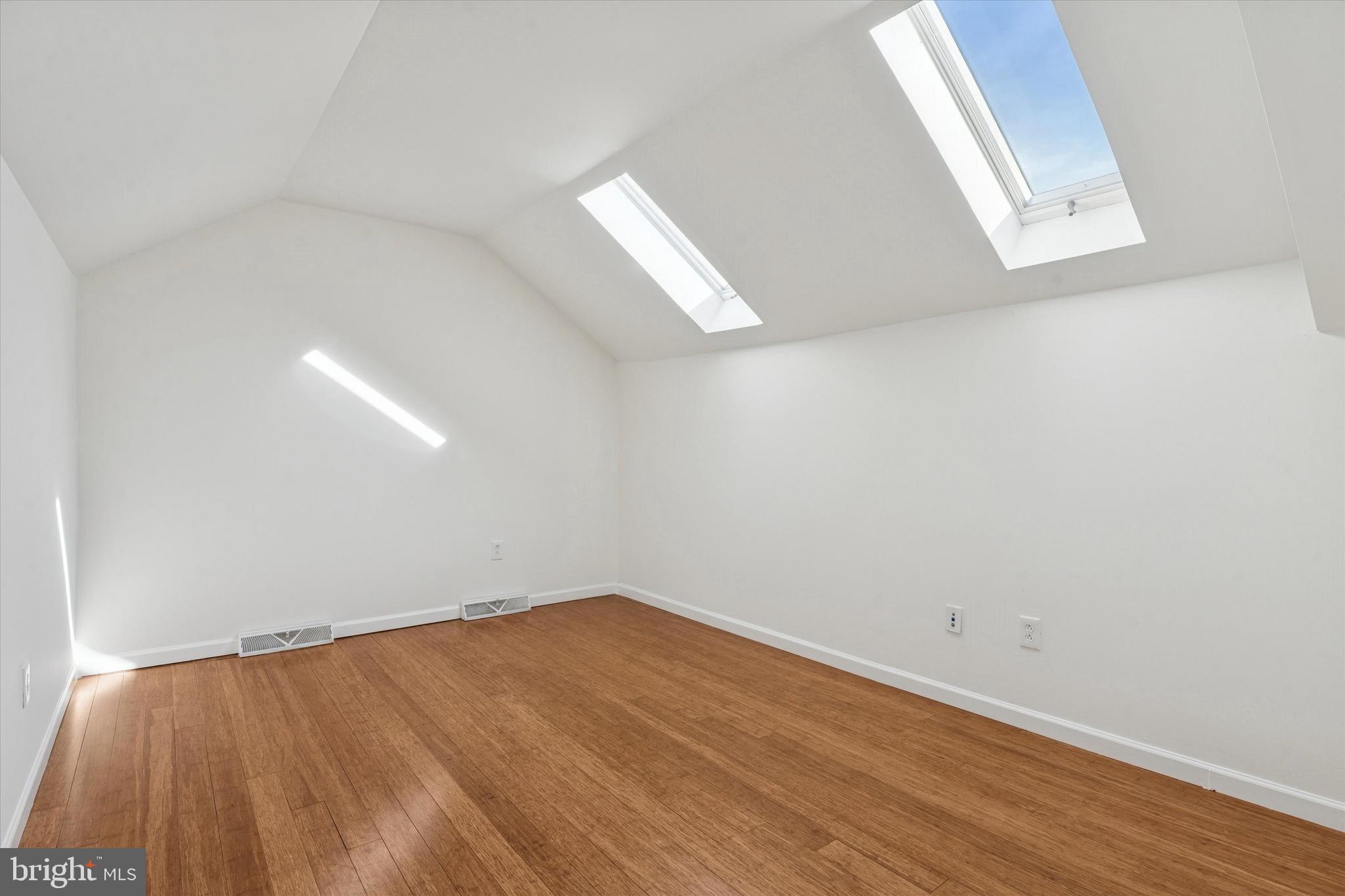 110 Hawk Drive Newark, DE 19702 - Photo 10 of 25 an empty room with wooden floor and windows