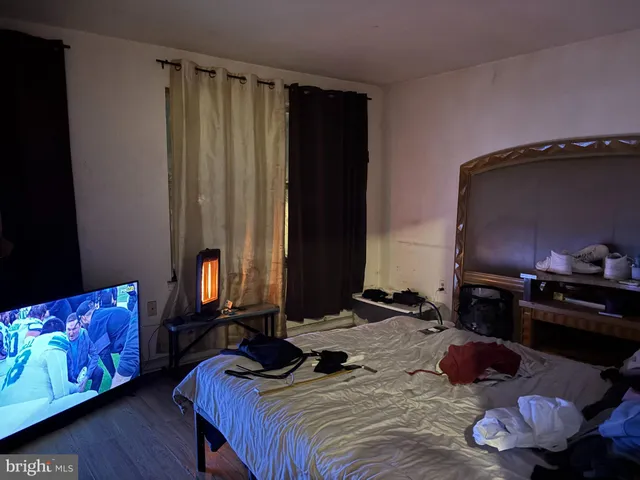 a bedroom with a bed and a television