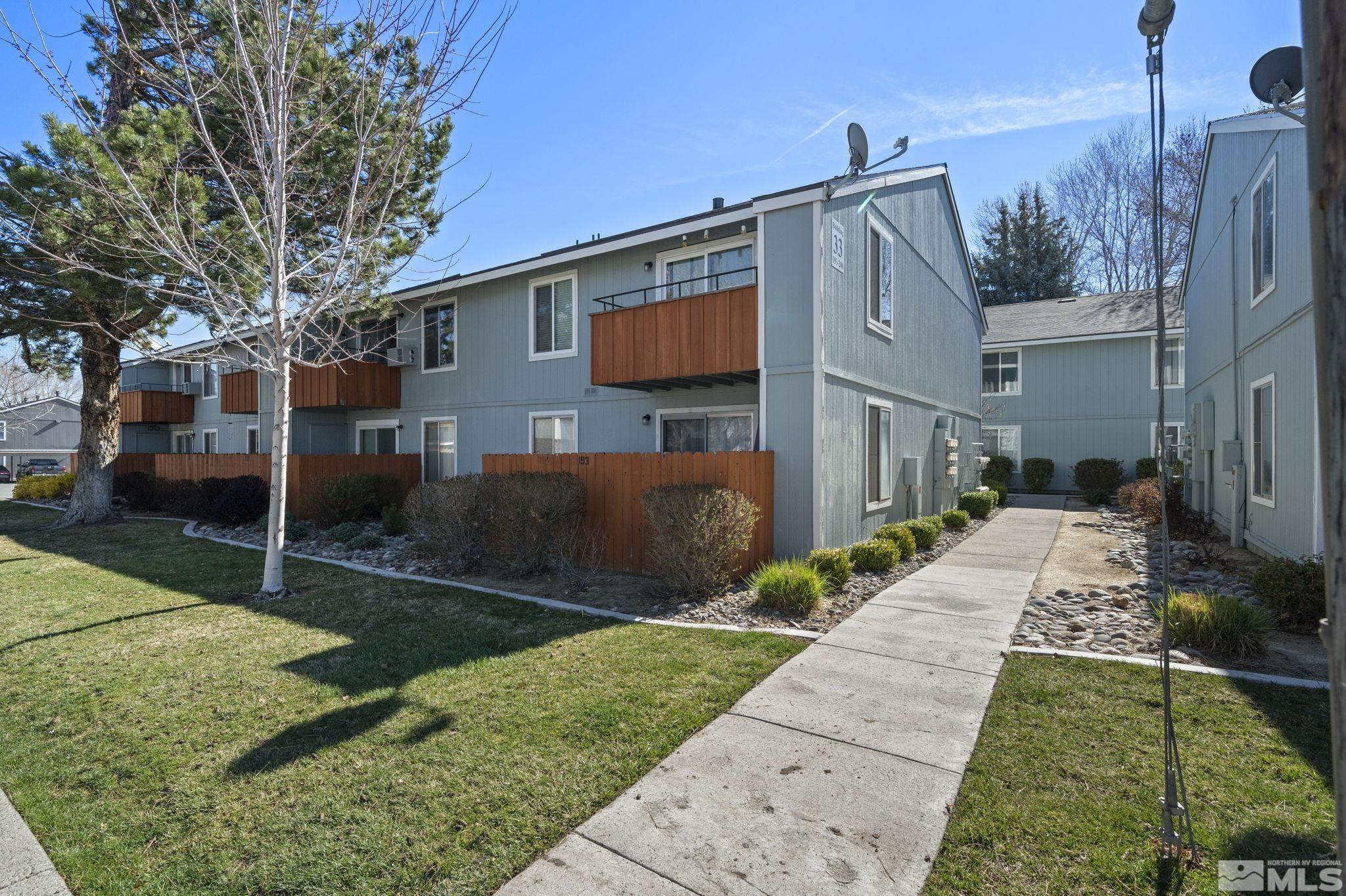 4606 Neil Road, Unit 193 Reno, NV 89502 - Photo 1 of 28 a view of a house with a yard and large tree