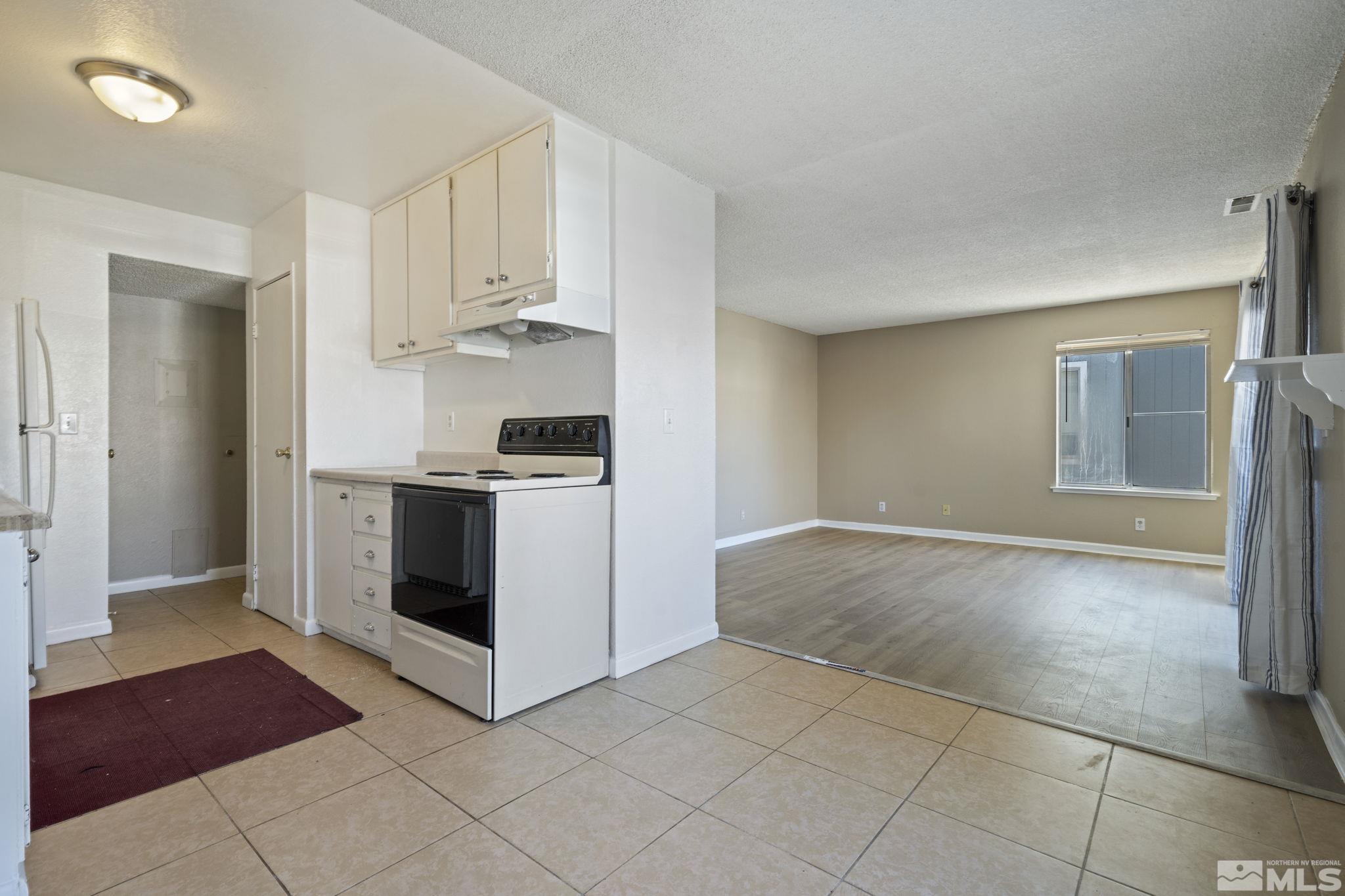 4606 Neil Road, Unit 193 Reno, NV 89502 - Photo 15 of 28 a kitchen with stainless steel appliances granite countertop a stove a sink and a refrigerator