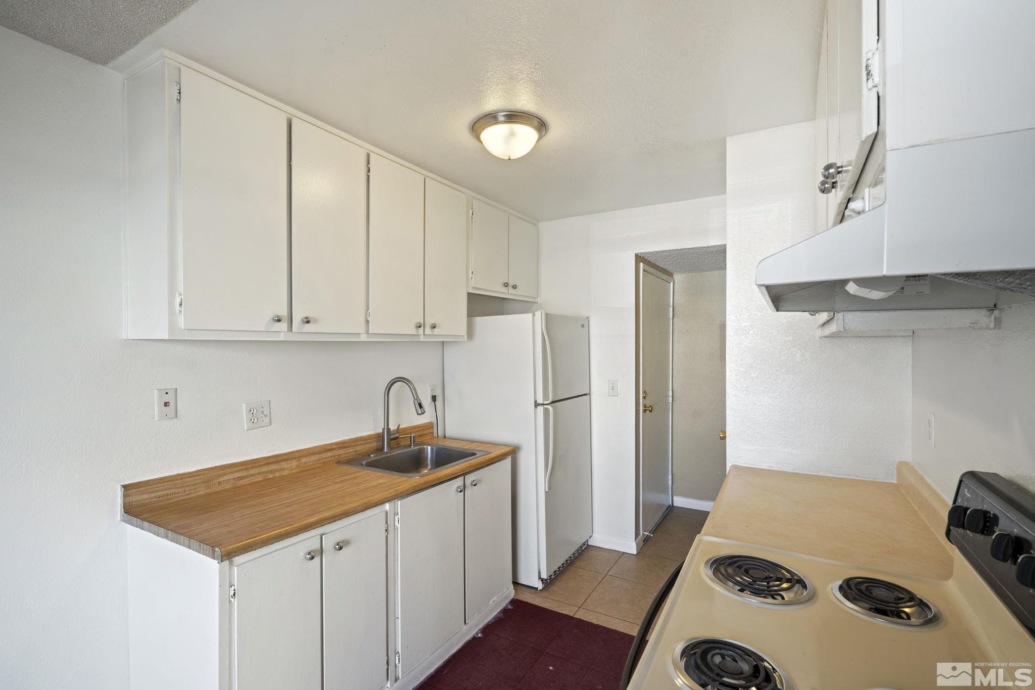 4606 Neil Road, Unit 193 Reno, NV 89502 - Photo 18 of 28 a kitchen with a refrigerator and a stove top oven