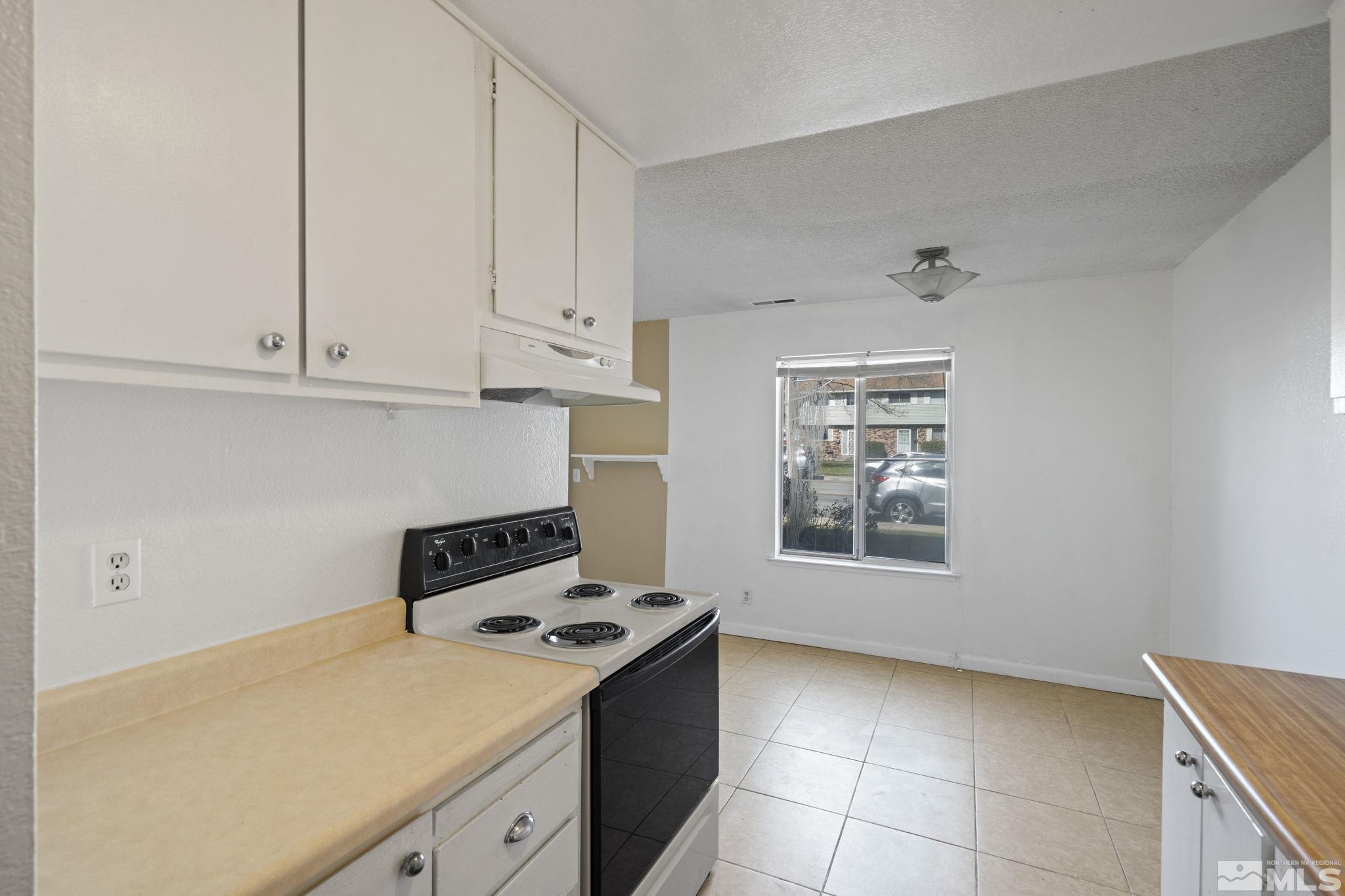 4606 Neil Road, Unit 193 Reno, NV 89502 - Photo 19 of 28 a kitchen with a stove and a view of kitchen