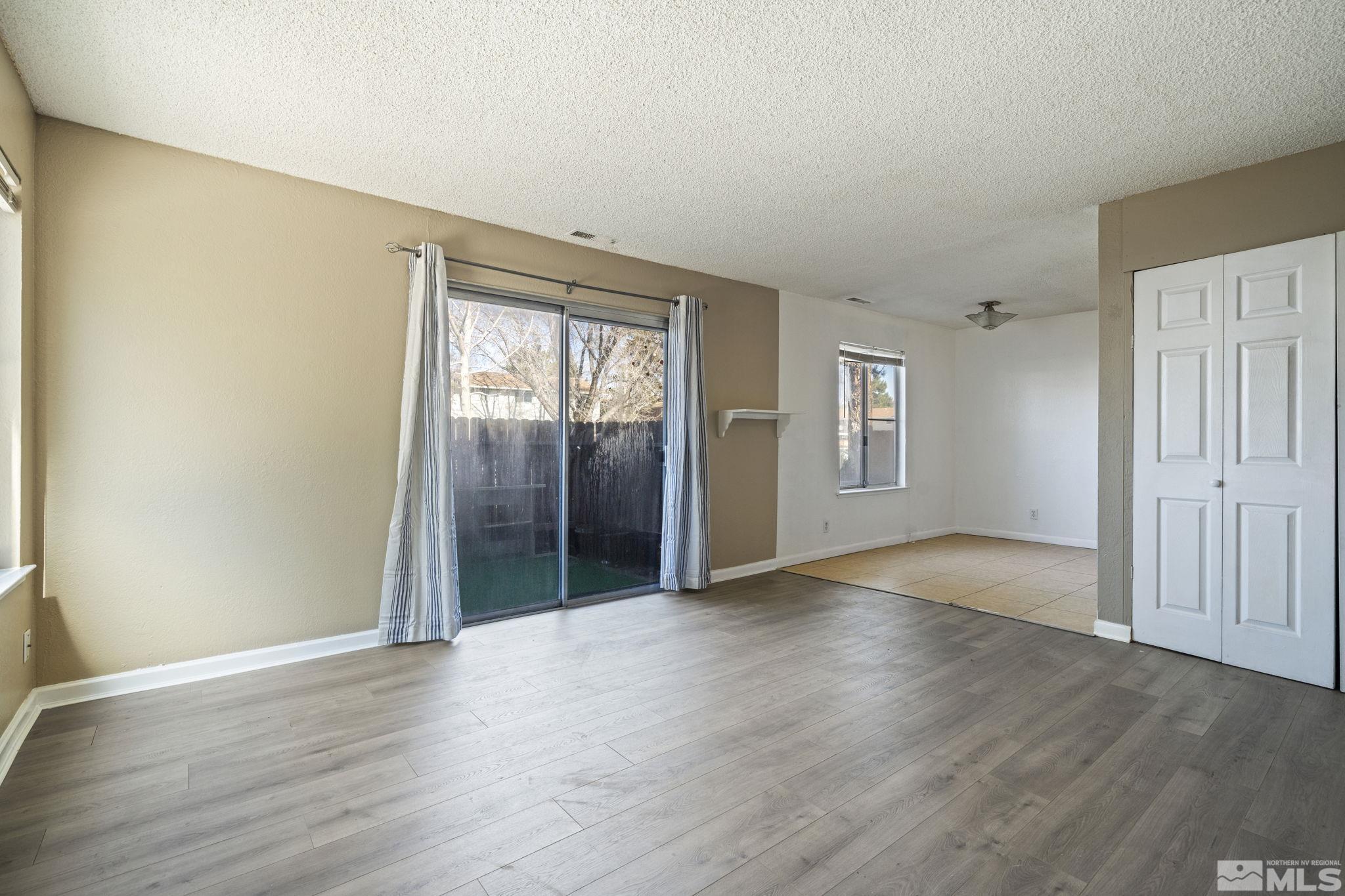 4606 Neil Road, Unit 193 Reno, NV 89502 - Photo 10 of 28 an empty room with wooden floor and windows