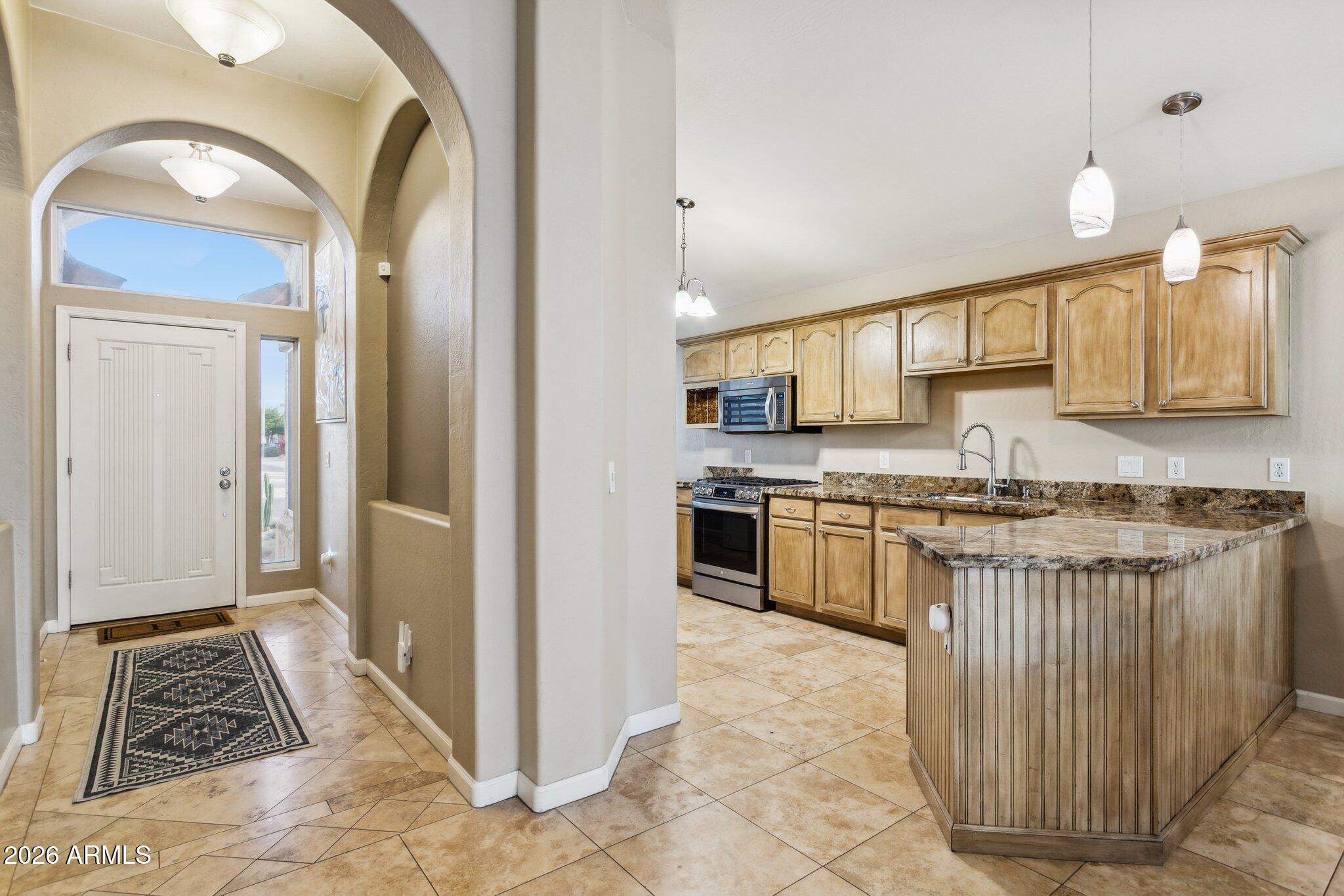 20238 North 9th Street Phoenix, AZ 85024 - Photo 11 of 38 a kitchen with stainless steel appliances granite countertop a stove a sink and a refrigerator