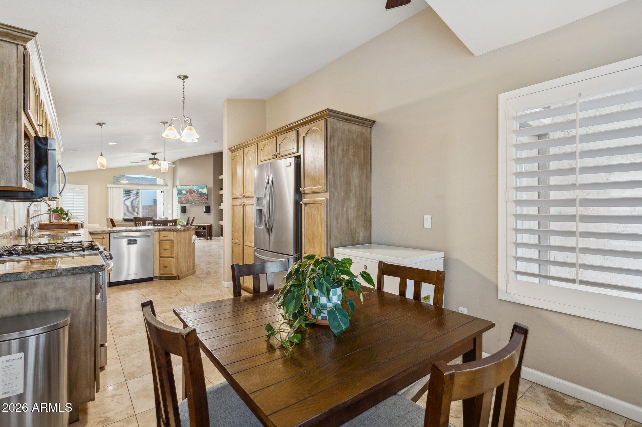 20238 North 9th Street Phoenix, AZ 85024 - Photo 14 of 38 a kitchen with stainless steel appliances granite countertop a dining table chairs and granite counter tops