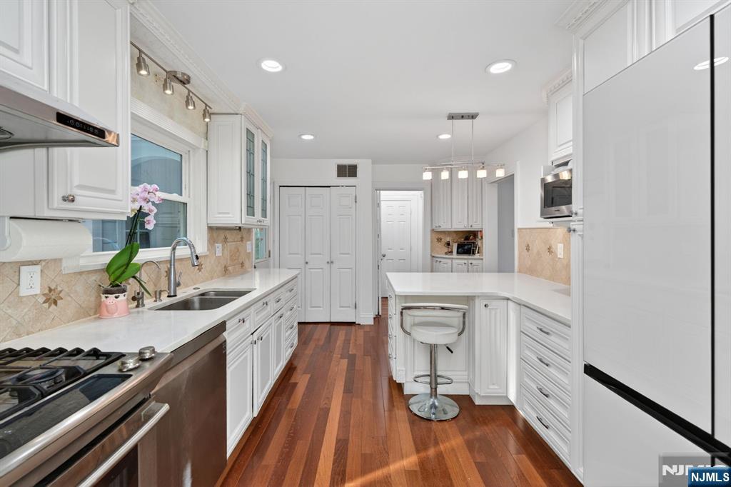 85 Whitney Road Short Hills, NJ 07078 - Photo 11 of 34 a kitchen with white cabinets and appliances