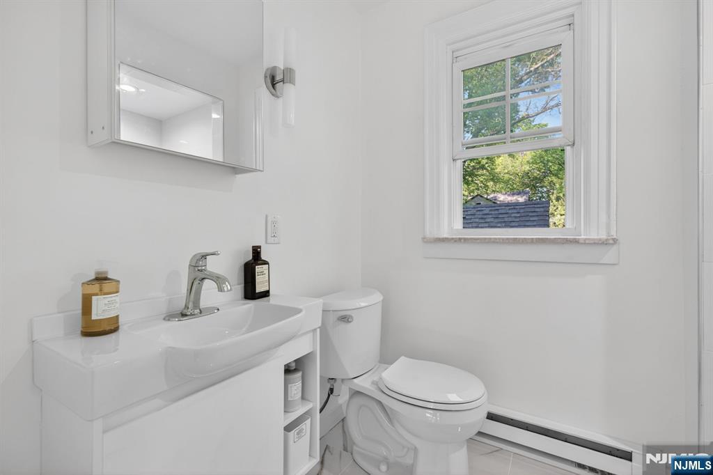 85 Whitney Road Short Hills, NJ 07078 - Photo 17 of 34 a bathroom with a sink a toilet and a window