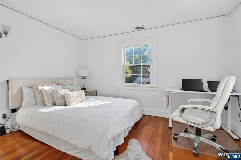 85 Whitney Road Short Hills, NJ 07078 - Photo 19 of 34 a bedroom with a bed and a chair