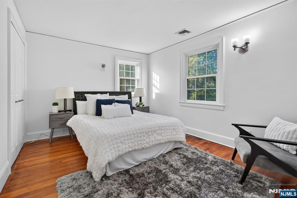 85 Whitney Road Short Hills, NJ 07078 - Photo 20 of 34 a bedroom with a bed and wooden floor