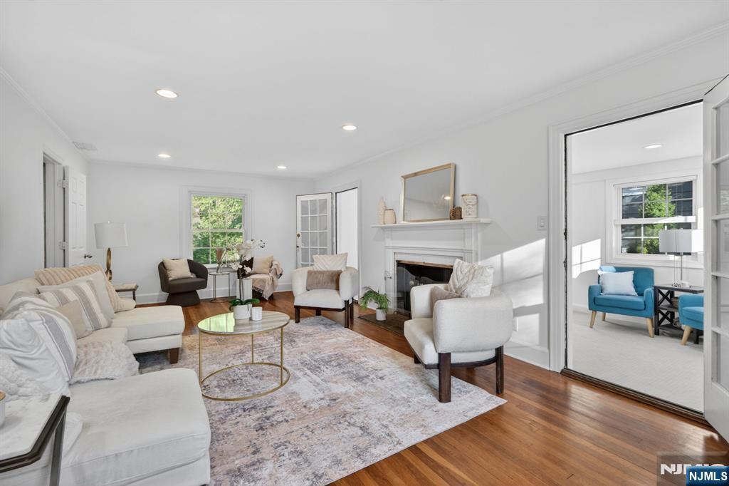 85 Whitney Road Short Hills, NJ 07078 - Photo 2 of 34 a living room with furniture a fireplace and a table