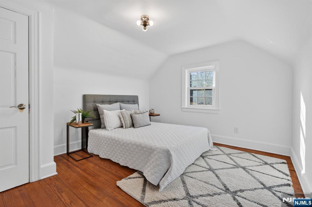 85 Whitney Road Short Hills, NJ 07078 - Photo 23 of 34 a bedroom with a bed and a lamp on dresser
