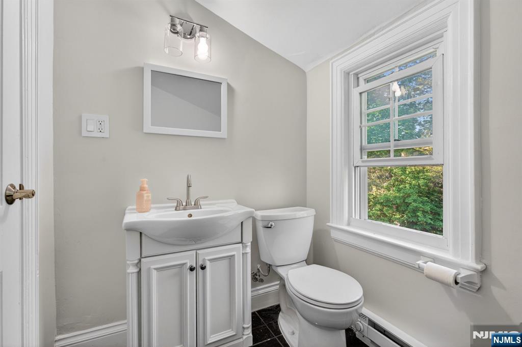 85 Whitney Road Short Hills, NJ 07078 - Photo 25 of 34 a bathroom with a toilet a sink and a window