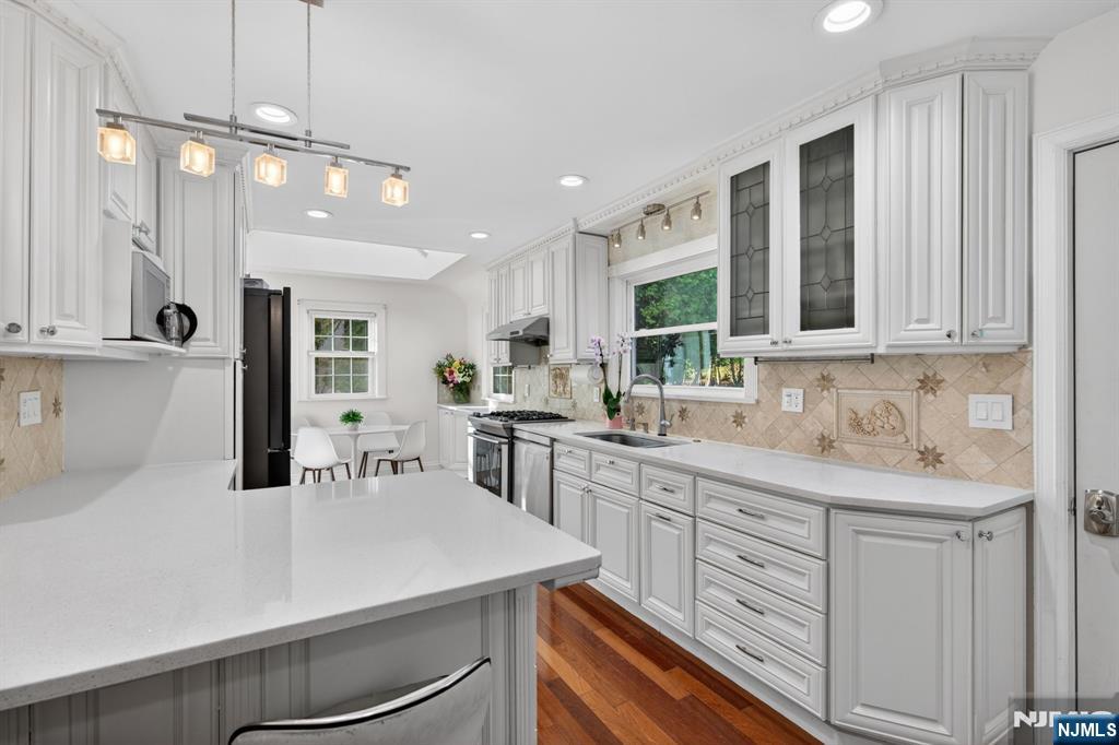 85 Whitney Road Short Hills, NJ 07078 - Photo 10 of 34 a kitchen with kitchen island a sink appliances and cabinets