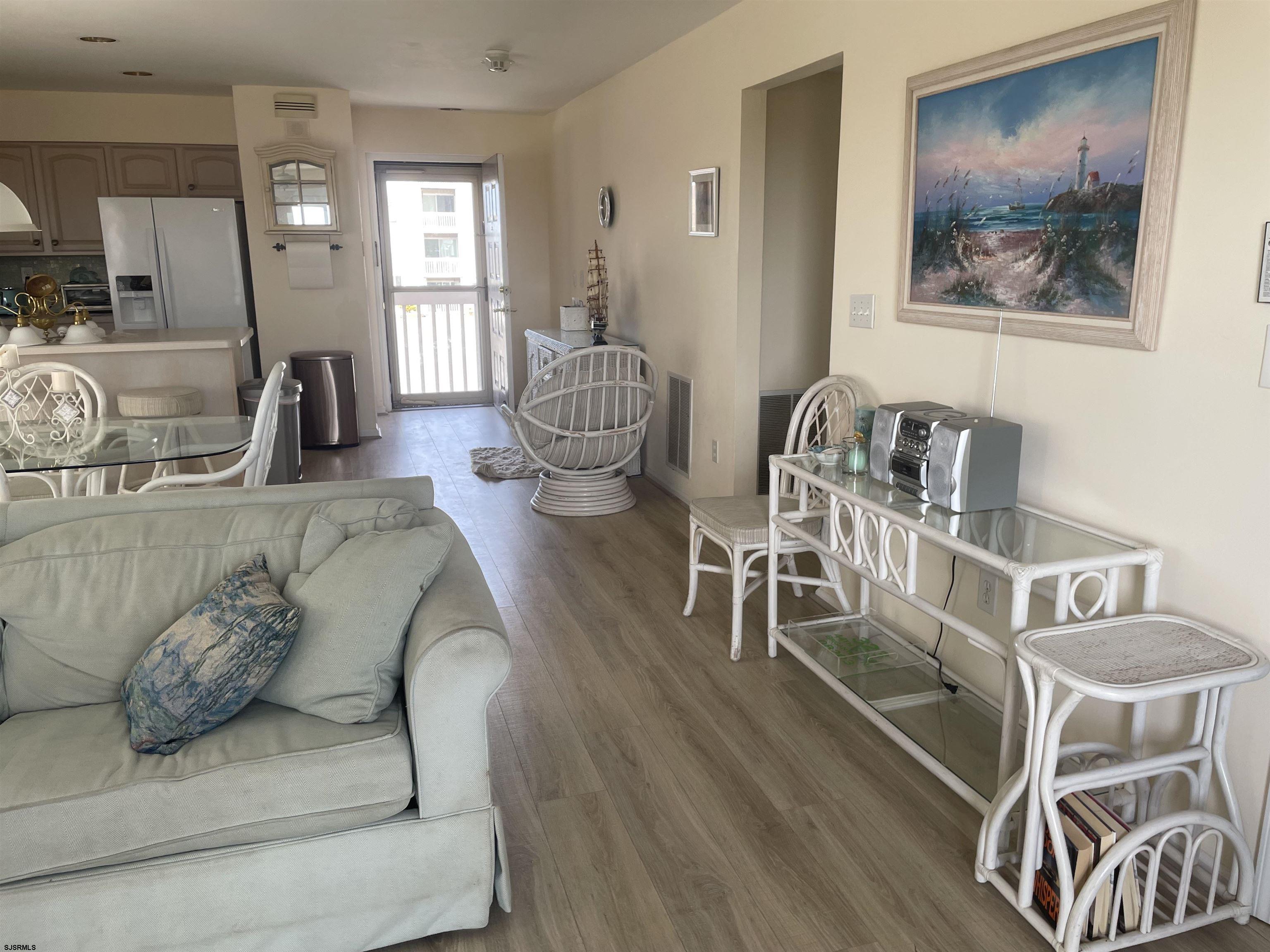 323 44th Street South, Unit 108 Brigantine, NJ 08203 - Photo 2 of 7 a living room with furniture and wooden floor