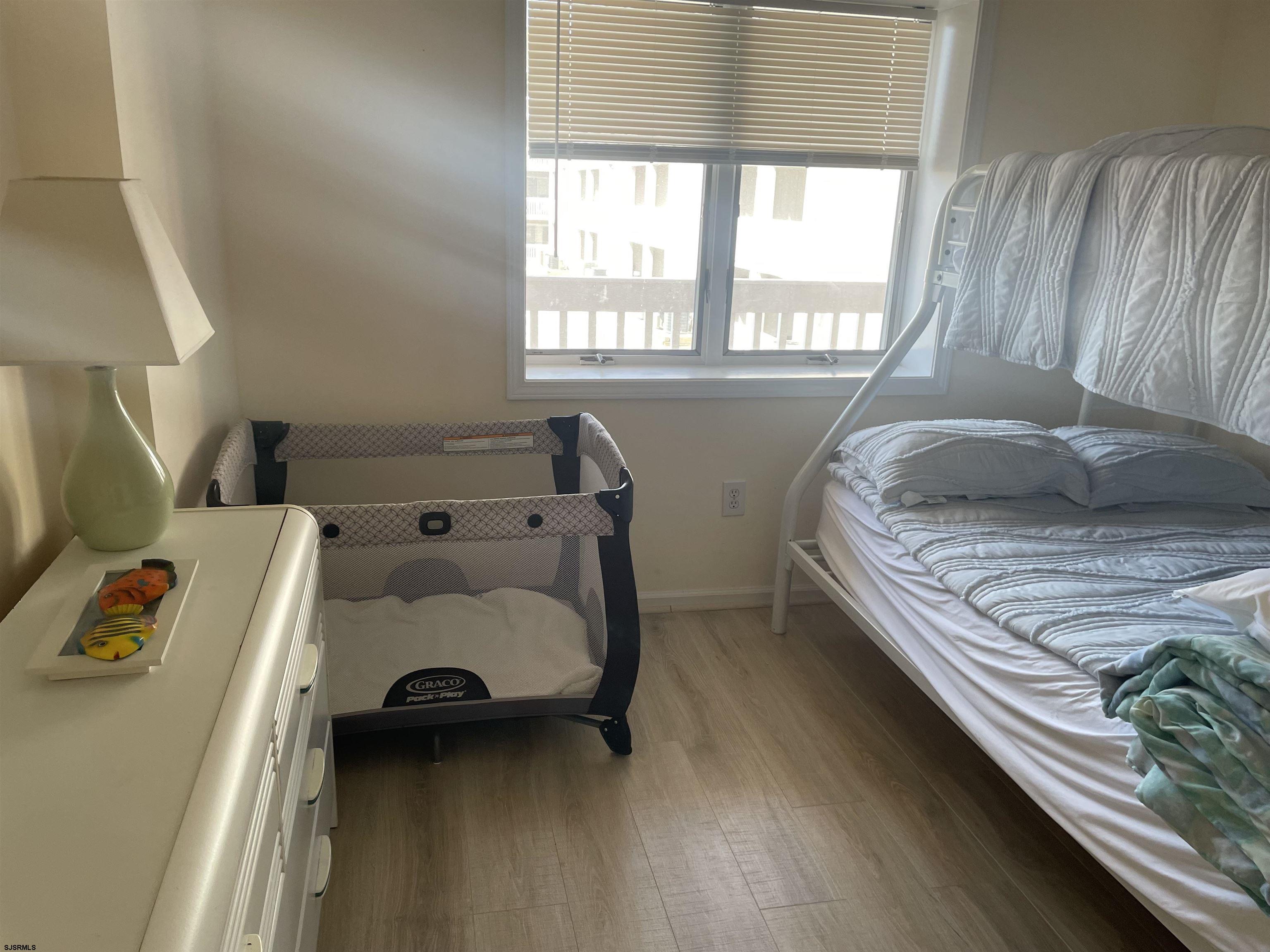 323 44th Street South, Unit 108 Brigantine, NJ 08203 - Photo 5 of 7 a bedroom with a bed and a window