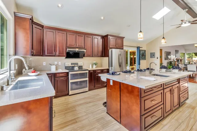 a kitchen with a table chairs and wooden floor