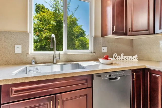 a large kitchen with stainless steel appliances granite countertop a stove and cabinets