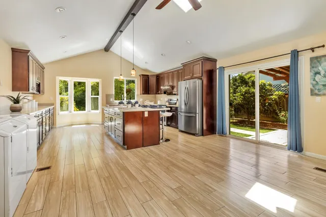 a view of a dining room with furniture wooden floor and chandelier