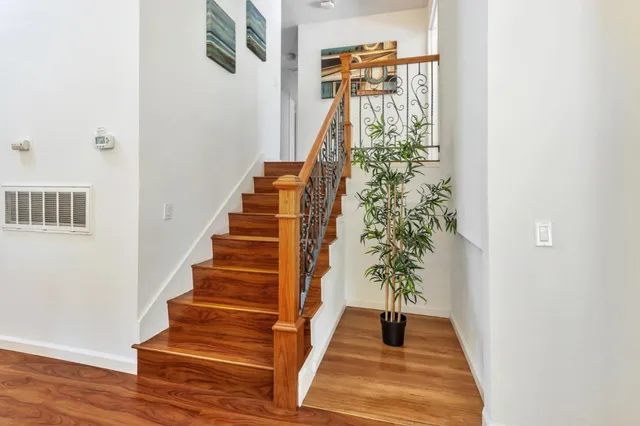 a bedroom with a bed and painting on the wall