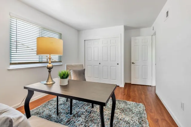 a bedroom with a bed and a table