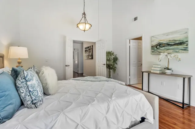 a bedroom with a bed and a night stand