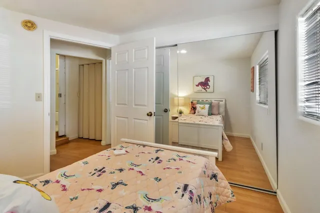 a bathroom with a granite countertop sink a mirror and painting on the wall