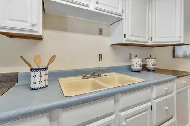 a view of a patio with a table chairs and a floor to ceiling window