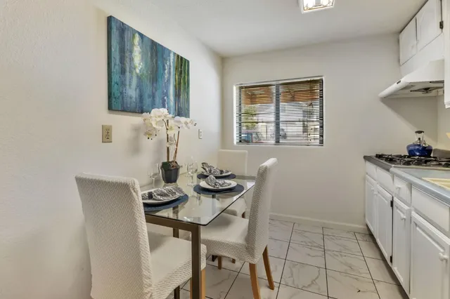 a view of a chairs in the patio next to a yard