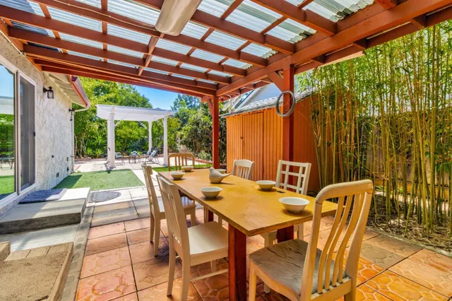 a building outdoor space with patio furniture and garden