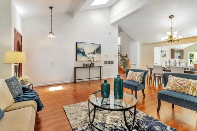 a living room with furniture and a painting on the wall