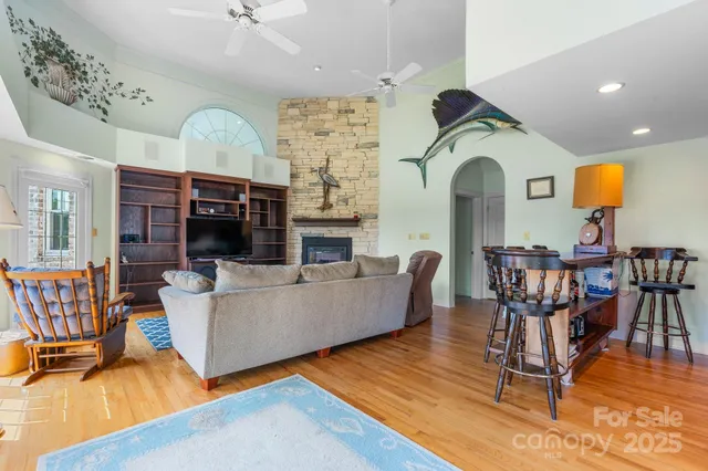 a living room with fireplace furniture and a wooden floor