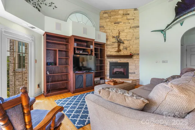 a living room with furniture a flat screen tv and a fireplace