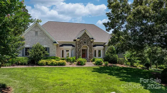 a front view of a house with a garden
