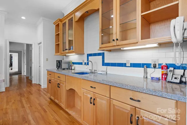 a kitchen with stainless steel appliances granite countertop a sink and cabinets