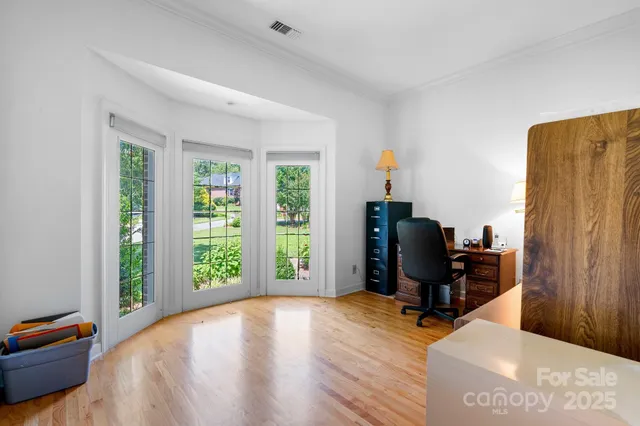 a view of a workspace with furniture and a window