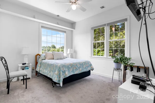 a bedroom with a bed and a potted plant
