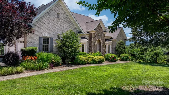 a front view of a house with a garden