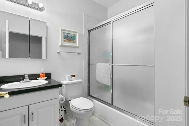 a bathroom with a shower sink and toilet