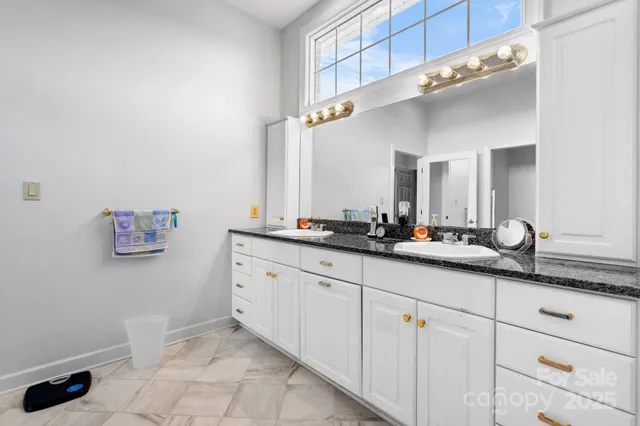 a bathroom with a double vanity sink and a mirror